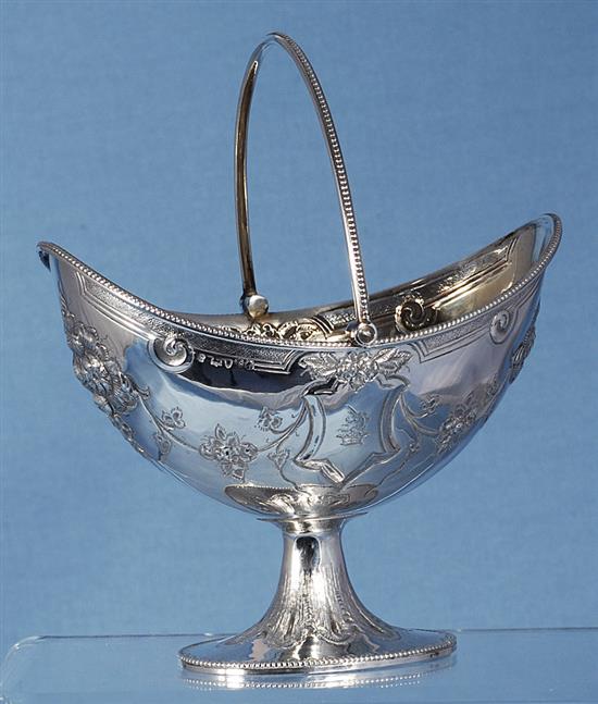 A Victorian silver swing handled sugar basket and sifter spoon, by Martin, Hall & Co, basket height 190mm, weight 7.7oz/241grms.